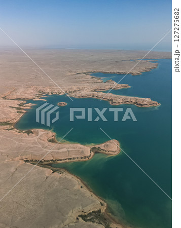 Aerial: turquoise coves and dry terrain at Kuimazar Reservoir in Uzbekistan Aerial: turquoise coves and dry terrain at Kuimazar Reservoir in Uzbekistan 127275682