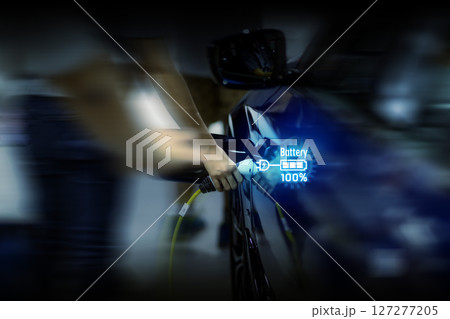 Power cable pump plug in charging power to electric vehicle EV car. 127277205