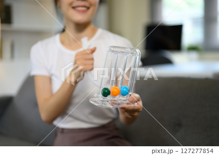 Incentive Spirometer or triflow on woman hand with medical home pre checking Incentive Spirometer or triflow on woman hand with medical home pre checking 127277854