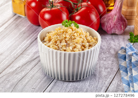 Vegan cuisine - boiled bulgur garnish Vegan cuisine - boiled bulgur garnish 127278496