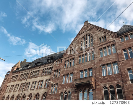 A large brick building with a blue sky in the background 127278968