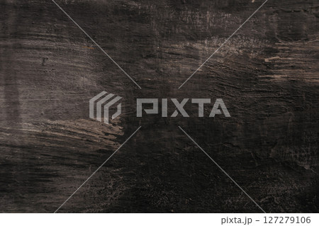 A dark wood grain background with a few brush strokes 127279106