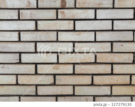 A brick wall with a white brick pattern 127279130