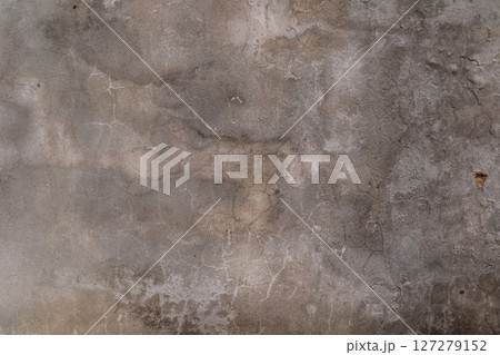 A grey wall with cracks and holes 127279152