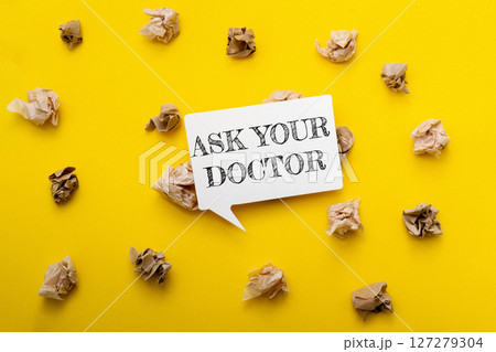 A yellow background with a white sign that says Ask Your Doctor A yellow background with a white sign that says Ask Your Doctor 127279304