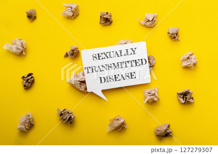 A yellow background with a white sign that says Sexually Transmitted Disease A yellow background with a white sign that says Sexually Transmitted Disease 127279307