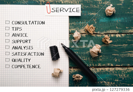 Piece of paper with a list of words and a black marker on it 127279336