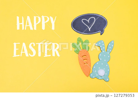 Yellow background with a carrot and a rabbit on it 127279353