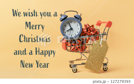 Shopping cart with a clock and a gold tag on it 127279393