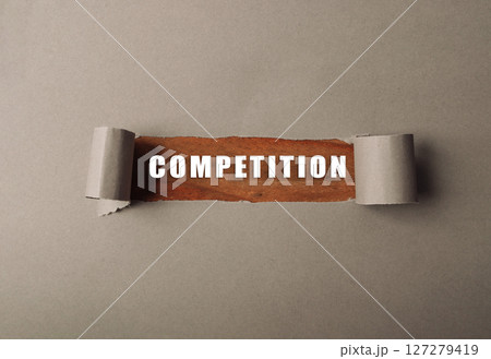 Torn piece of paper with the word competition written on it Torn piece of paper with the word competition written on it 127279419