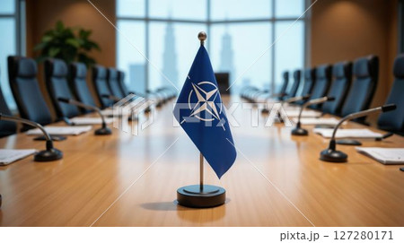 NATO flag in empty boardroom with soft lighting 127280171