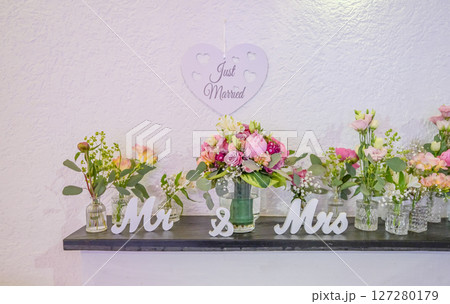 Wedding decor. Close up of a wedding table decoration with white and pink flowers and candles Wedding floristic concept Wedding decor. Close up of a wedding table decoration with white and pink flowers and candles Wedding floristic concept 127280179