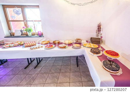 Candy bar pink wedding decorated standing of festive table with deserts, strawberry tartlet and cupcakes Candy bar pink wedding decorated standing of festive table with deserts, strawberry tartlet and cupcakes 127280207