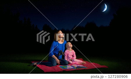 Mother and Daughter Stargazing Under Night Sky in Backyard 127280906
