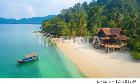 Tropical island beach view with a house and traditional wooden boat near 127281234