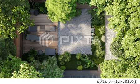Beautiful tranquil garden with wooden deck, stone paths, and lush greenery 127282051