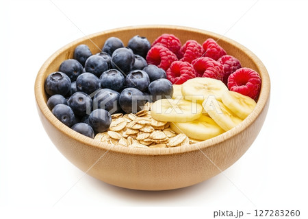 Vibrant Healthy Breakfast Bowl Featuring Fresh Fruits, Oats, and Nuts Arranged Neatly for a Delightful Start 127283260