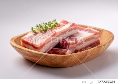 Close up of view of fresh slices of raw pork belly on a wooden plate. Meat concept 127283384