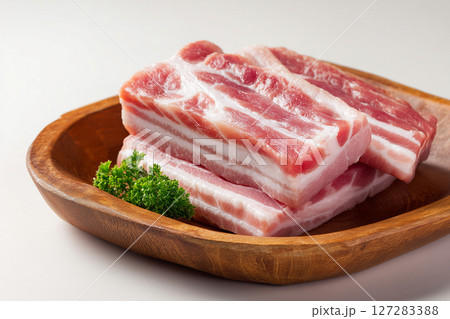 Close up of view of fresh raw pork belly on a wooden plate. Meat concept 127283388