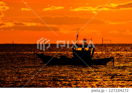 fishing boats on the beach at sunset fishing boats on the beach at sunset 127284272