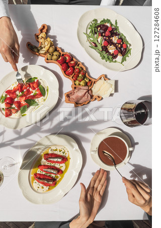Flat lay of table with gourmet dishes and eating 127284608