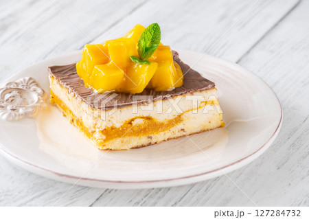 Mango Cheesecake Square Topped With Mango Cubes and Mint Leaf 127284732