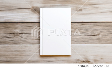 White notebook lying on wooden table, minimalist writing concept 127285078