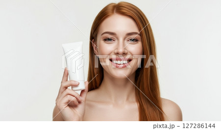 Redhead Woman Holding Skincare Tube Beautiful Smiling Face Clean Beauty Product 127286144