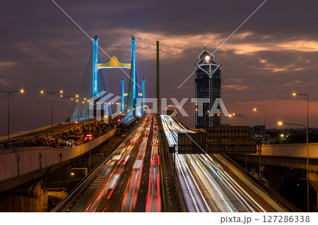 Thotsamarachan Bridge (Rama IX Bridge) crossing Chao phraya river. Beautiful city of Bangkok during sunset time. Thotsamarachan Bridge (Rama IX Bridge) crossing Chao phraya river. Beautiful city of Bangkok during sunset time. 127286338