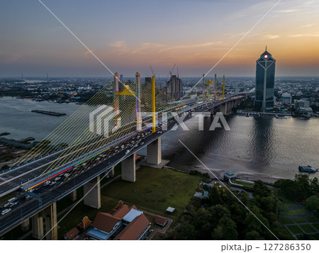 Thotsamarachan Bridge (Rama IX Bridge) crossing Chao phraya river. Beautiful city of Bangkok during sunset time. Thotsamarachan Bridge (Rama IX Bridge) crossing Chao phraya river. Beautiful city of Bangkok during sunset time. 127286350