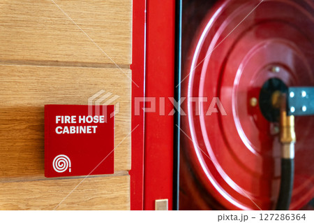 Fire Safety Concept, Fire extinguisher, Fire protection cabinet with fire hydrant and hose reel in public building corridor. 127286364