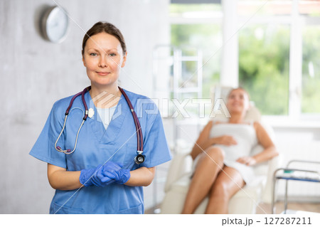 Adult female doctor posing in medical room Adult female doctor posing in medical room 127287211