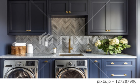 Modern Laundry Room with Navy Cabinets, Herringbone Tile, and Stainless Steel Appliances 127287906