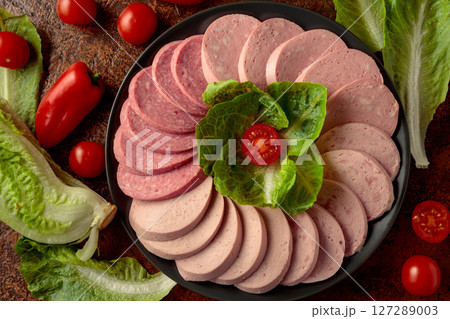 Various boiled sausages with greens and vegetables. Various boiled sausages with greens and vegetables. 127289003