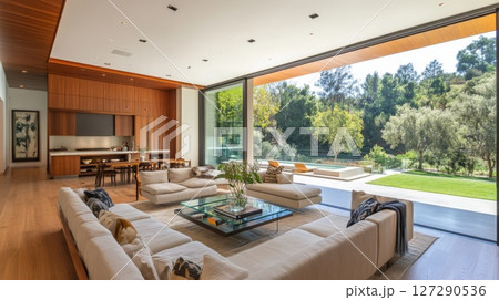 Modern Living Room with Sliding Glass Doors Opening to a Backyard with a Pool and Lush Greenery 127290536