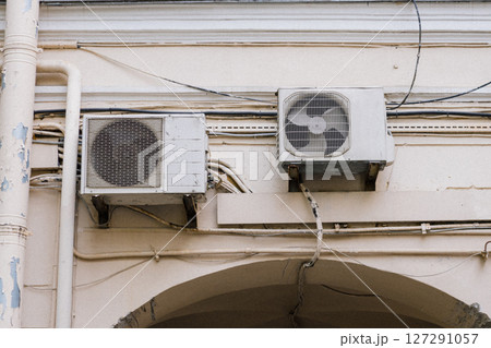 Air conditioning on facade of building and windows in the southern hot country. Air conditioning on facade of building and windows in the southern hot country. 127291057