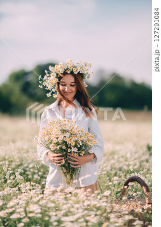 Daisies Woman Flowers: Girl collects summer bouquet in field, sunny day, enjoying nature, with basket. 127291084