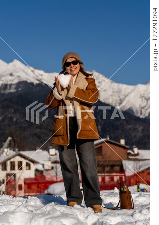 Snow Woman Mountains Winter: Heart-shaped snow, sunny Alps village, joyful winter activity. 127291094