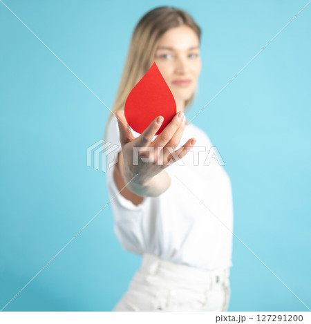Woman holding red blood drop mockup as symbol of blood donation Woman holding red blood drop mockup as symbol of blood donation 127291200