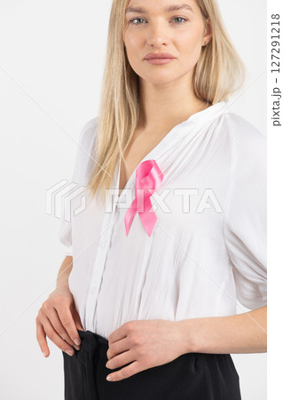 Woman with pink ribbon as a symbol of breast cancer 127291218