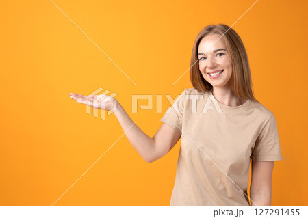 Young Woman Presenting with Hand Gesture 127291455