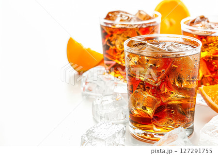 Three glasses of soda with ice cubes and an orange slice 127291755