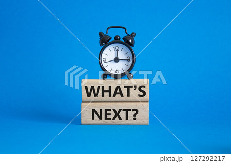 What is next symbol. Concept words What is next on wooden blocks. Beautiful blue background with alarm clock. Business and What is next concept. Copy space. What is next symbol. Concept words What is next on wooden blocks. Beautiful blue background with alarm clock. Business and What is next concept. Copy space. 127292217
