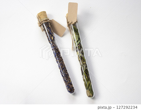 Glass tubes with Dried flowers and herbs. Paper tags with copy space Glass tubes with Dried flowers and herbs. Paper tags with copy space 127292234