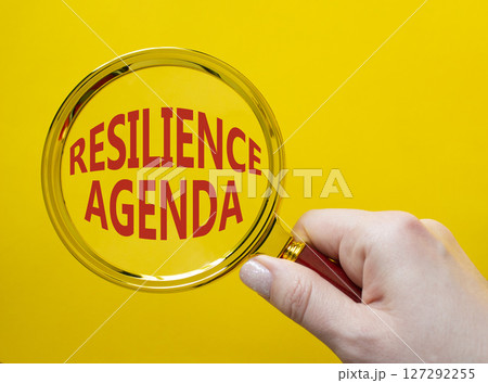 Resilience agenda symbol. Magnifying glass with words Resilience agenda. Beautiful yellow background. Businessman hand. Business and Resilience agenda concept. Copy space. Resilience agenda symbol. Magnifying glass with words Resilience agenda. Beautiful yellow background. Businessman hand. Business and Resilience agenda concept. Copy space. 127292255