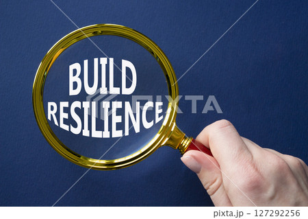 Build resilience symbol. Magnifying glass with words Build resilience. Beautiful deep blue background. Businessman hand. Business and Build resilience concept. Copy space. Build resilience symbol. Magnifying glass with words Build resilience. Beautiful deep blue background. Businessman hand. Business and Build resilience concept. Copy space. 127292256