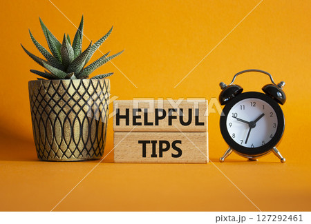 Helpful tips symbol. Wooden blocks with words Helpful tips. Beautiful orange background with alarm clock and succulent plant. Business and Helpful tips concept. Copy space. Helpful tips symbol. Wooden blocks with words Helpful tips. Beautiful orange background with alarm clock and succulent plant. Business and Helpful tips concept. Copy space. 127292461