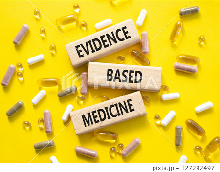 Evidence Based Medicine symbol. Concept word Evidence Based Medicine on wooden blocks. Beautiful yellow background with pills. Medicine and Evidence Based Medicine concept. Copy space Evidence Based Medicine symbol. Concept word Evidence Based Medicine on wooden blocks. Beautiful yellow background with pills. Medicine and Evidence Based Medicine concept. Copy space 127292497
