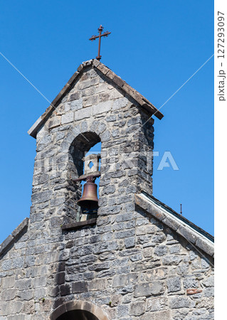 Bells toll in the serene stone chapel in Roncevaux along the Camino de Santiago, French Pyrenees 127293097