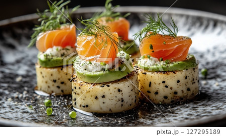 Artisanal toast topped with smoked salmon, creamy avocado, and dill served on a marble countertop Artisanal toast topped with smoked salmon, creamy avocado, and dill served on a marble countertop 127295189